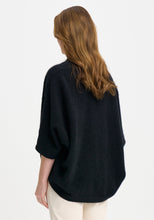 Load image into Gallery viewer, Possum and Merino

100276 Naomi Wrap - This clever little piece is part wrap and part cardi, and the best part - it can be flipped upside down. Want a longer silhouette, then wear it one way, want it cropped then turn it around! Featuring a pocket detail and a waterfall-style silhouette, this style can also be wrapped. Relaxed fit.

Made in New Zealand from an exclusive Merinomink blend of 50% ZQ Merino, 40% Brushtail possum and 10% Mulberry silk.