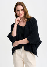 Load image into Gallery viewer, Possum and Merino

100276 Naomi Wrap - This clever little piece is part wrap and part cardi, and the best part - it can be flipped upside down. Want a longer silhouette, then wear it one way, want it cropped then turn it around! Featuring a pocket detail and a waterfall-style silhouette, this style can also be wrapped. Relaxed fit.

Made in New Zealand from an exclusive Merinomink blend of 50% ZQ Merino, 40% Brushtail possum and 10% Mulberry silk.