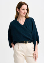 Load image into Gallery viewer, Possum and Merino

100276 Naomi Wrap - This clever little piece is part wrap and part cardi, and the best part - it can be flipped upside down. Want a longer silhouette, then wear it one way, want it cropped then turn it around! Featuring a pocket detail and a waterfall-style silhouette, this style can also be wrapped. Relaxed fit.

Made in New Zealand from an exclusive Merinomink blend of 50% ZQ Merino, 40% Brushtail possum and 10% Mulberry silk.