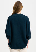 Load image into Gallery viewer, Possum and Merino

100276 Naomi Wrap - This clever little piece is part wrap and part cardi, and the best part - it can be flipped upside down. Want a longer silhouette, then wear it one way, want it cropped then turn it around! Featuring a pocket detail and a waterfall-style silhouette, this style can also be wrapped. Relaxed fit.

Made in New Zealand from an exclusive Merinomink blend of 50% ZQ Merino, 40% Brushtail possum and 10% Mulberry silk.