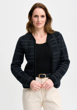 Load image into Gallery viewer, Possum and Merino

100298 Eloise Jacket - Eloise is all about style and grace. A refined silhouette and soft v neckline is met with a zipper that comes down to a curved front hem. A Merinomink zip pull and pockets add to the thoughtful design of this jacket. With a felted finish and subtle check detail, this new jacket is poised to become a highly coveted piece. Slim fit.&nbsp;

Made in New Zealand from an exclusive Merinomink blend of 50% ZQ Merino, 40% Brushtail possum and 10% Mulberry silk.