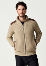 Load image into Gallery viewer, Possum and Merino

100392 Forrester Jacket - Crafted with a distinctive fisherman rib knit, this jacket combines timeless design with considered detailing. Leather shoulder patches and leather-trimmed pockets lend a heritage-inspired character, while the signature Merinomink zip pull provides a refined finishing touch. A versatile layer designed for enduring style and comfort.

Made in New Zealand from a blend of 40% possum fur, 50% ZQ  merino and 10% mulberry silk.