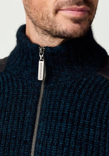 Load image into Gallery viewer, Possum and Merino

100392 Forrester Jacket - Crafted with a distinctive fisherman rib knit, this jacket combines timeless design with considered detailing. Leather shoulder patches and leather-trimmed pockets lend a heritage-inspired character, while the signature Merinomink zip pull provides a refined finishing touch. A versatile layer designed for enduring style and comfort.

Made in New Zealand from a blend of 40% possum fur, 50% ZQ merino and 10% mulberry silk.