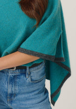 Load image into Gallery viewer, Possum and Merino

1623 Two Tone Poncho - A fan favourite, the Two Tone Poncho is a winner. With a relaxed fit and contrast coloured tipping it&#39;s cut for comfort and style. With a rainbow of colour options on offer, this is one you&#39;ll want in each colour! Classic fit.&nbsp;

Made in New Zealand from an exclusive Merinomink blend of 50% ZQ Merino, 40% Brushtail possum and 10% Mulberry silk.
