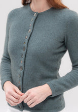 Load image into Gallery viewer, Possum and Merino  1736 Shell Cardigan -  An endearing little cardi inspired by our love of New Zealand. The natural paua shell buttons take on the hue of the knit, and with most of the buttons being decorative, it&#39;s easy to get on and off! 