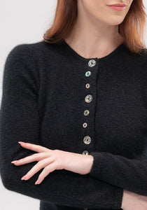 Possum and Merino  1736 Shell Cardigan -  An endearing little cardi inspired by our love of New Zealand. The natural paua shell buttons take on the hue of the knit, and with most of the buttons being decorative, it's easy to get on and off! 