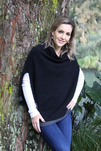 Possum and Merino  Z145 Verge Poncho - Striking and practical this softly draped turtleneck poncho features slits for ease of arm movement.  A small contrast stripe accents the soft curve of the hemline.
