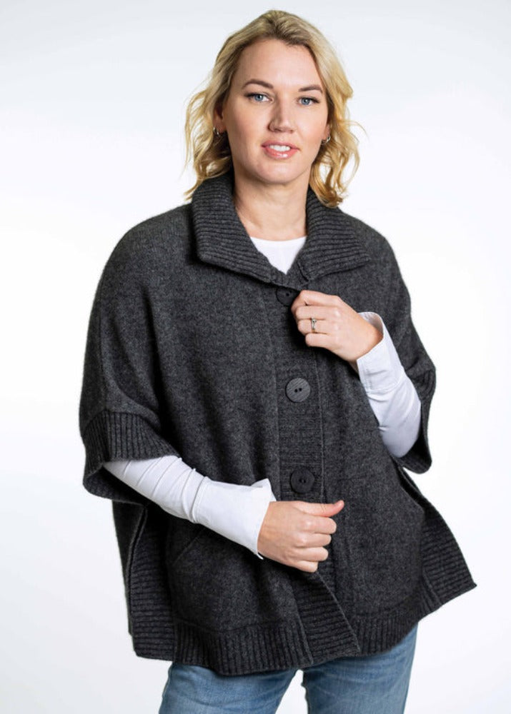 Possum and Merino  KO552 Cape with Pockets - An easy to wear piece which features ribbed trims, knitted-in pockets and beautiful textured buttons.  This garment is ideal for layering and is a relaxed fit.  Made proudly in New Zealand from a premium blend of 40% possum fur, 50% merino lambswool & 10% mulberry silk.  