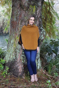 Possum and Merino  Z145 Verge Poncho - Striking and practical this softly draped turtleneck poncho features slits for ease of arm movement.  A small contrast stripe accents the soft curve of the hemline.